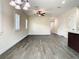 View of the living room showing the staircase and a dining area near large windows and a ceiling fan at 4209 W Woodlawn Ave, Tampa, FL 33614