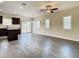 Open-concept living room featuring hardwood floors, modern ceiling fan, and plenty of natural light at 4209 W Woodlawn Ave, Tampa, FL 33614
