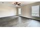 Living room with hardwood floors, two windows, a ceiling fan, and baseboard at 4209 W Woodlawn Ave, Tampa, FL 33614