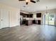 Bright and airy living room featuring an open kitchen, stainless appliances, and hardwood flooring at 4209 W Woodlawn Ave, Tampa, FL 33614