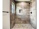 Shower featuring decorative tile, rain shower head and design, and built-in toiletry shelf at 4209 W Woodlawn Ave, Tampa, FL 33614