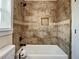 Tiled shower and tub combination features decorative tile border and accents at 4209 W Woodlawn Ave, Tampa, FL 33614