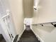 A view of the stairway with white risers and wood treads and white railing on each side of the stairwell at 4209 W Woodlawn Ave, Tampa, FL 33614