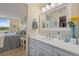 Well-lit bathroom with a spacious vanity area and a peek into the adjoining bedroom, featuring a tranquil, modern design at 4410 Fairways Blvd # 104, Bradenton, FL 34209