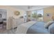 Comfortable bedroom with large window providing views of the outside, complimented by bright colors and serene decor at 4410 Fairways Blvd # 104, Bradenton, FL 34209