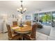 Bright dining area features a chandelier, seating for four, and access to the balcony at 4410 Fairways Blvd # 104, Bradenton, FL 34209