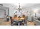 Cozy dining area with chandelier and seating for four is connected to the kitchen at 4410 Fairways Blvd # 104, Bradenton, FL 34209