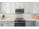 Stylish kitchen featuring modern stainless appliances, sleek counter tops, and attractive backsplash at 4410 Fairways Blvd # 104, Bradenton, FL 34209