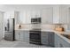 Modern kitchen with stainless steel appliances, two-tone cabinets, and stylish backsplash at 4410 Fairways Blvd # 104, Bradenton, FL 34209