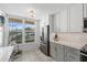 Well-lit kitchen features gray cabinets, stainless steel appliances, light countertops, and a window with a view at 4410 Fairways Blvd # 104, Bradenton, FL 34209