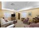 A relaxing living room features comfortable seating, a television, and natural light at 4410 Fairways Blvd # 104, Bradenton, FL 34209
