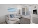 Cozy living room featuring a comfortable couch, bright window, and stylish decor at 4410 Fairways Blvd # 104, Bradenton, FL 34209