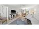 Open living room with view into dining area and access to balcony at 4410 Fairways Blvd # 104, Bradenton, FL 34209