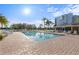A refreshing community pool features chairs and an adjacent covered patio for relaxation at 4410 Fairways Blvd # 104, Bradenton, FL 34209