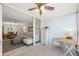 This sunroom with tile flooring and a ceiling fan seamlessly connects to the adjacent living and dining areas at 4410 Fairways Blvd # 104, Bradenton, FL 34209