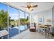 Bright sunroom features ceiling fan, a cozy chair, and sliding glass doors opening to a spacious balcony with views at 4410 Fairways Blvd # 104, Bradenton, FL 34209