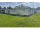 Well-maintained backyard with green grass and home's exterior, showcasing ample outdoor space at 48 Dade Ave, Sarasota, FL 34232