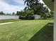 Expansive backyard featuring lush green grass and a storage shed for outdoor equipment at 48 Dade Ave, Sarasota, FL 34232
