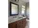 Bathroom featuring a white marble countertop with a wood vanity and modern fixtures at 48 Dade Ave, Sarasota, FL 34232