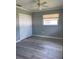 A cozy bedroom with laminate floors, a ceiling fan and closet space at 48 Dade Ave, Sarasota, FL 34232