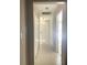 Bright hallway with tiled floors and closet space, leading to various rooms in the home at 48 Dade Ave, Sarasota, FL 34232
