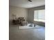 Inviting living room featuring neutral tones, a comfortable chair, and ample natural light at 48 Dade Ave, Sarasota, FL 34232