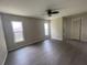 Spacious main bedroom with wood laminate floors, two windows, a ceiling fan and closet at 48 Dade Ave, Sarasota, FL 34232