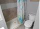 Compact bathroom showcases tiled shower and toilet at 5118 Oakland Hills Ave, Sarasota, FL 34234