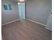 Comfortable bedroom featuring gray walls, new flooring and lots of light at 5118 Oakland Hills Ave, Sarasota, FL 34234