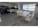 Bright dining area featuring a table with white chairs and a kitchen view at 5118 Oakland Hills Ave, Sarasota, FL 34234