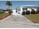 Cozy single-story home featuring a palm tree and driveway in a well-maintained community at 5118 Oakland Hills Ave, Sarasota, FL 34234