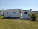 Home's exterior showing the yard and landscaping at 5118 Oakland Hills Ave, Sarasota, FL 34234