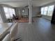 Bright living room with vinyl floors, multiple windows and a rocking chair at 5118 Oakland Hills Ave, Sarasota, FL 34234