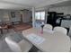 Open-concept living and dining areas with vinyl floors, ceiling fan and kitchen view at 5118 Oakland Hills Ave, Sarasota, FL 34234