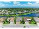 Beautiful home with lush green landscaping and a view of a serene lake and natural surroundings at 518 Chantilly Trl, Bradenton, FL 34212