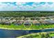 Picturesque aerial view of a home with a pool, surrounded by a lush green lawn and peaceful lake at 518 Chantilly Trl, Bradenton, FL 34212