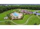 Aerial view of the community pool, playground, clubhouse, and surrounding greenery at 518 Chantilly Trl, Bradenton, FL 34212