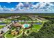 Beautiful aerial view of the community pool, playground, clubhouse, and meticulously landscaped grounds, all set amongst lovely ponds at 518 Chantilly Trl, Bradenton, FL 34212