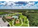 Aerial view showcasing the community pool, playground, and well-maintained green spaces at 518 Chantilly Trl, Bradenton, FL 34212
