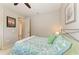 Bedroom featuring a full bed with green decorative pillows and an open doorway to the hall at 518 Chantilly Trl, Bradenton, FL 34212