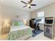 Bright bedroom featuring a ceiling fan, full bed, exercise bike, and an arcade game at 518 Chantilly Trl, Bradenton, FL 34212