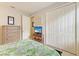 Bedroom with a full bed, dresser, television on stand, and a double door closet at 518 Chantilly Trl, Bradenton, FL 34212