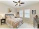 Bright bedroom featuring two windows, a ceiling fan, and a queen-sized bed at 518 Chantilly Trl, Bradenton, FL 34212