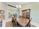 Dining room with chandelier, wood table, decorative cabinet, and adjacent living spaces at 518 Chantilly Trl, Bradenton, FL 34212