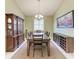 Formal dining room with wood table, decorative cabinet, and a painting at 518 Chantilly Trl, Bradenton, FL 34212