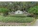 Attractive stone entrance sign for Greyhawk Landing, framed by lush greenery, creating a welcoming entry to the neighborhood at 518 Chantilly Trl, Bradenton, FL 34212