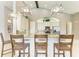 Open kitchen with granite counters, large island, breakfast bar, and modern appliances at 518 Chantilly Trl, Bradenton, FL 34212