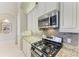 Up close view of the cooktop and granite counters in this well-equipped kitchen at 518 Chantilly Trl, Bradenton, FL 34212