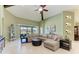 Spacious living room featuring high ceilings, a ceiling fan, and large windows at 518 Chantilly Trl, Bradenton, FL 34212