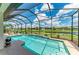 Screened-in pool overlooking a canal with lounge chairs and landscaping at 518 Chantilly Trl, Bradenton, FL 34212